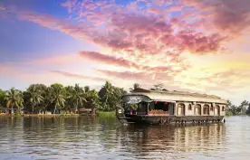 Ship cruising along the waters, with a colourful blue and purple sunset approaching