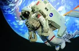 Floating astronaut in a white space suit with the earth behind them