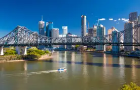 Ferry boat under Story Bridge with skyline of Brisbane, Queensland, Australia
