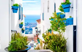 Narrow street in Mijas tourist town of the white villages in Andalusia, Spain
