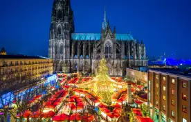 Christmas market and Catholic cathedral at night in the city of Cologne, Germany