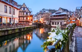 Canal and illuminated buildings during a Christmas market in Strasbourg, France