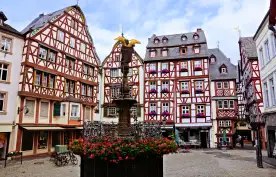 Beautiful Market Square with fountain, flowers and half timbered buildings in Bernkastel-Kues, Germany