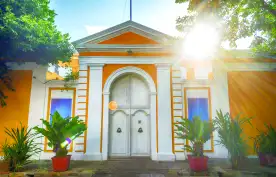 Colourful yellow and white house displaying French architecture. Pondicherry