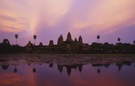 A distant view of Angkor Wat, a temple complex in Cambodia, at twilight
