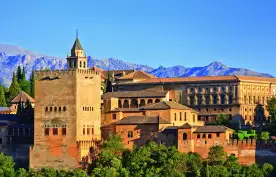 View on Alhambra at sunset with distant mountains in the background, Spain