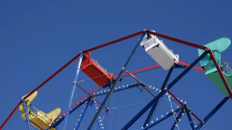 Colorful Ferris wheel against a bright blue sky