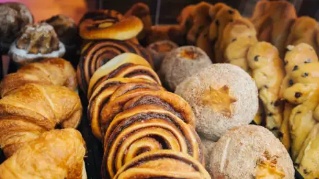 A variety of cakes and pastries on a market stall.