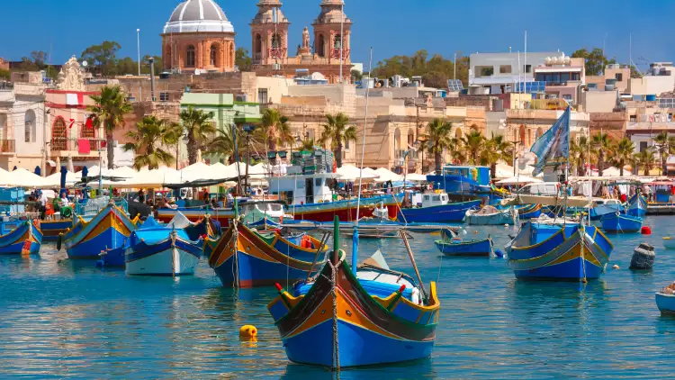 Traditional colourful eyed boats Luzzu at harbour in Marsaxlokk, Malta