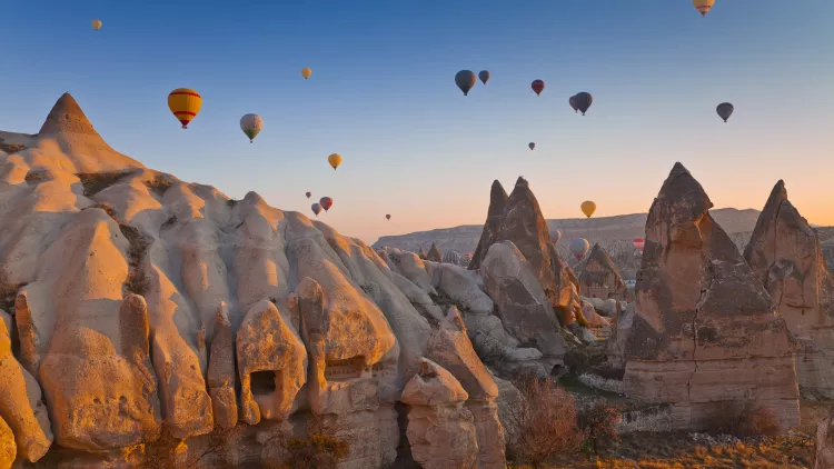 Hot air balloons rising up in the sky, in Cappadocia, Turkey.