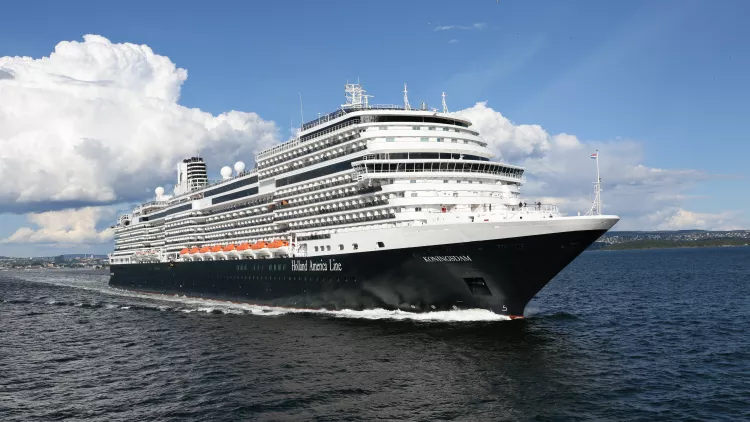 Exterior of the MS Koningsdam in motion along the sea, a Holland America Line ship