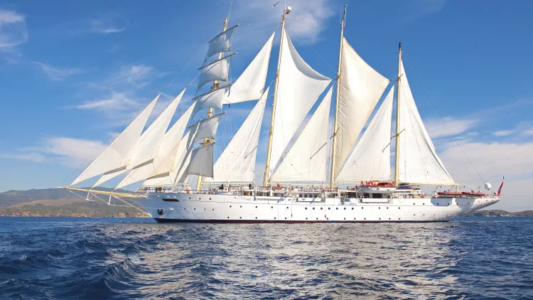 Exterior of the Star Clipper tall ship sailing under a blue sky