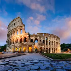 Image of the ancient Colosseum in Rome Italy against a beautiful sunset sky