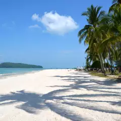 Pantai Cenang beach with white sands and palm trees in Langkawi, Malaysia