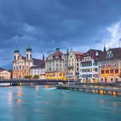 The Reuss River with surrounding buildings during a stormy evening in Lucerne, Switzerland