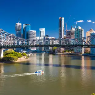 Ferry boat under Story Bridge with skyline of Brisbane, Queensland, Australia