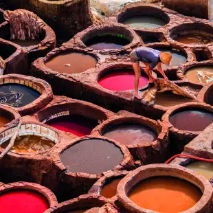 Man working in leather tanneries in medina Fez, Morocco