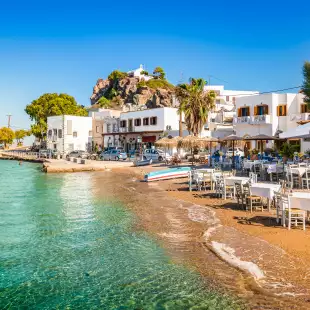 Bright and colourful view of Skala town with small beach in Patmos, Greece