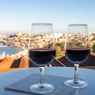 Two port wines in glasses with view of the Douro river and city of Porto, Portugal