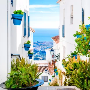 Narrow street in Mijas tourist town of the white villages in Andalusia, Spain