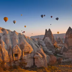 Hot air balloons rising up in the sky, in Cappadocia, Turkey.