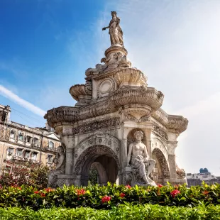 Flora fountain featuring a stone statue of Roman goddess in Mumbai, India