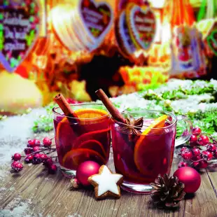 Two decorated glasses of mulled wine at German Christmas market stall