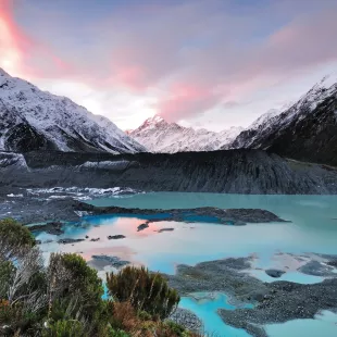 Blue waters and mountains at Mount Cook National Park in New Zealand