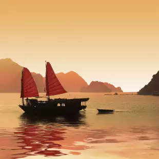 Junk boat at sunset in Halong Bay, Vietnam