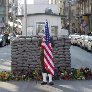 US Army Checkpoint with soldier holding the US flag in Berlin, Germany