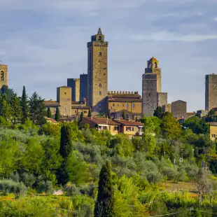 San Gimignano, a small walled medieval hill town with lush vegetation in Siena, Italy