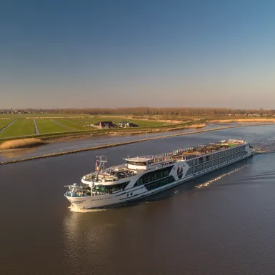 Distant side shot of the George Eliot, on a river