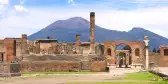Ruins of Pompeii and a distant view of  Mount Vesuvius volcano in Italy
