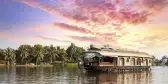 Ship cruising along the waters, with a colourful blue and purple sunset approaching