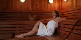 Woman relaxing in a sauna in a white towel at the Marriott Guanacaste Resort and Spa, Costa Rica