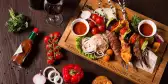 A charcuterie board, close-up of food and ingredients on wooden chopping board