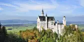 Aerial of Neuschwanstein castle surrounded by vegetation in Bavaria, Germany