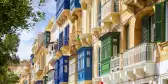 Traditional closed wooden balconies on the streets of Valletta, Malta