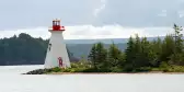 Distant view of Kidston lighthouse on Bras D'Or lake in Canada