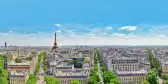 A view of Paris rooftops with the Eifel Tower on the horizon