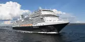 Exterior of the MS Koningsdam in motion along the sea, a Holland America Line ship