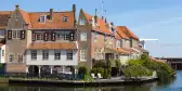 Dutch canal house under a calm blue sky
