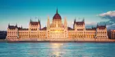 Parliament building with sun setting in windows in Budapest, Hungary