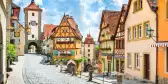 Historical half-timbered houses and cobbled streets of Rothenburg on a sunny day with blue sky and clouds in Franconia, Bavaria, Germany.