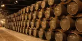 Stacks of port wine barrels in cellar at Graham's Port Lodge in Portugal