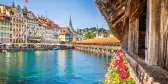 Famous Chapel Bridge in the historic city center of Lucerne, the city's symbol and one of Switzerland's main tourist attractions and views on a sunny day in summer, Canton of Lucerne, Switzerland