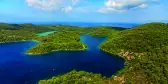 Aerial shot of the National Park on the island of Mijet, Croatia. Also known as a “green island” for its lush vegetation, its beauty consists of contrasting rocks, caves and cliffs against blue waters.