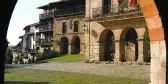 View of Santillana del Mar main square from an archway in Spain