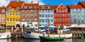 Colourful row of houses and canal with boats in Copenhagen, Denmark