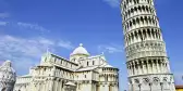 A low ground shot of the leaning tower of Pisa and the Campo dei Miracoli building, Italy